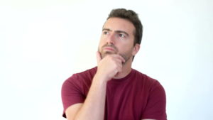Man questioning himself and wondering with doubtful face expression